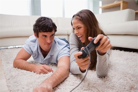 simsearch:400-05297936,k - Young woman just defeated her boyfriend at a video game Stock Photo - Budget Royalty-Free & Subscription, Code: 400-05748033