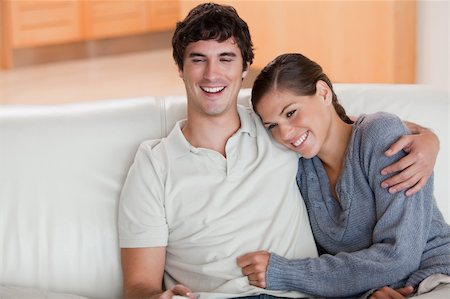 simsearch:400-05748048,k - Happy young couple enjoying their time together on the sofa Stockbilder - Microstock & Abonnement, Bildnummer: 400-05748057