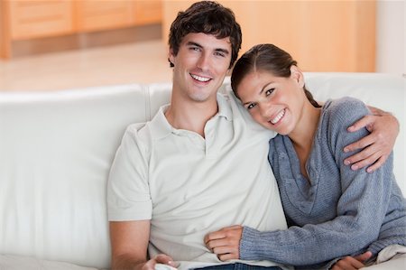 simsearch:400-05748048,k - Happy young couple enjoying their time together on the couch Stockbilder - Microstock & Abonnement, Bildnummer: 400-05748058