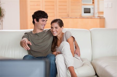 simsearch:400-05748048,k - Young couple on the sofa enjoying a movie together Stockbilder - Microstock & Abonnement, Bildnummer: 400-05748051