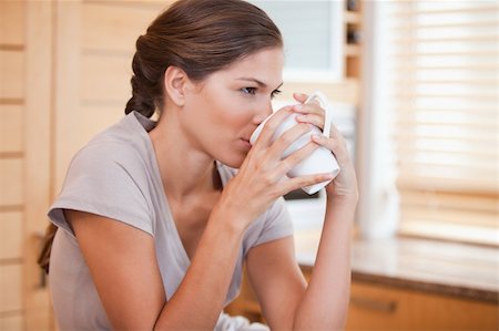 simsearch:400-04335902,k - Side view of young woman drinking coffee Stock Photo - Budget Royalty-Free & Subscription, Code: 400-05748103
