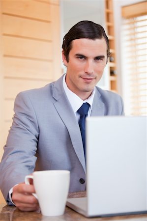 simsearch:400-05737647,k - Young businessman with laptop and tea Stock Photo - Budget Royalty-Free & Subscription, Code: 400-05748121