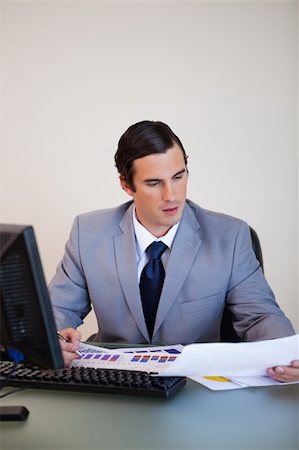 simsearch:400-05748158,k - Young businessman doing paperwork Stock Photo - Budget Royalty-Free & Subscription, Code: 400-05748146