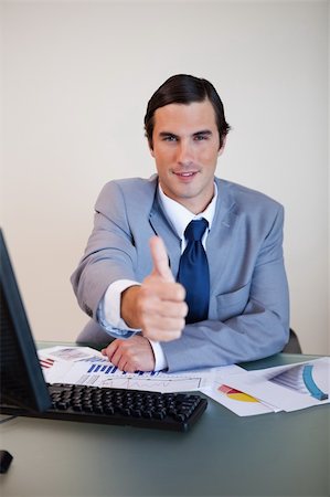 simsearch:400-05748158,k - Sitting businessman approves with thumb up Stock Photo - Budget Royalty-Free & Subscription, Code: 400-05748161