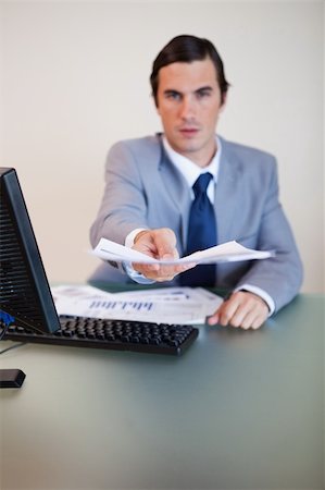 simsearch:400-05748158,k - Contract being handed over by businessman at his desk Stock Photo - Budget Royalty-Free & Subscription, Code: 400-05748172