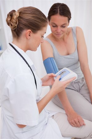 Doctor and patient measuring blood pressure together Stock Photo - Budget Royalty-Free & Subscription, Code: 400-05748211