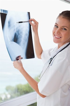 simsearch:400-06634198,k - Smiling doctor with x-ray and pen Stock Photo - Budget Royalty-Free & Subscription, Code: 400-05748250