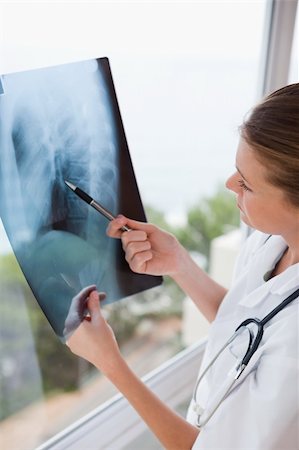 simsearch:400-06634198,k - Doctor with pen holding x-ray against window Stock Photo - Budget Royalty-Free & Subscription, Code: 400-05748251