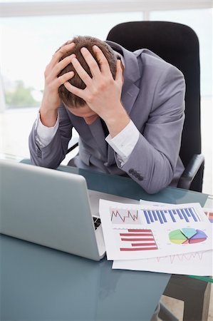 simsearch:400-05748158,k - Businessman at his desk frustrated by statistics Stock Photo - Budget Royalty-Free & Subscription, Code: 400-05748289