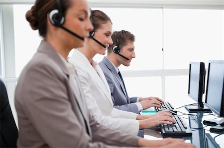 Side view of customer service assistants at work Stock Photo - Budget Royalty-Free & Subscription, Code: 400-05748311