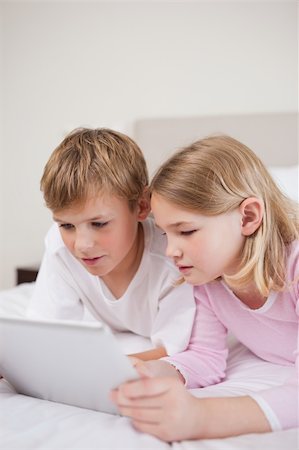 simsearch:400-04157521,k - Portrait of cute children using a tablet computer in a bedroom Stock Photo - Budget Royalty-Free & Subscription, Code: 400-05748390