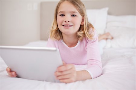 person tablet home information - Girl using a tablet computer in a bedroom Stock Photo - Budget Royalty-Free & Subscription, Code: 400-05748393