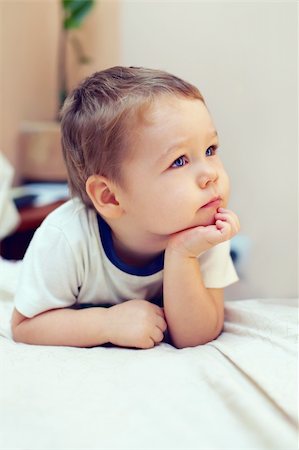simsearch:400-05745952,k - cute little serious  boy keeping his hands on the chin and focused on something interesting Stock Photo - Budget Royalty-Free & Subscription, Code: 400-05748501