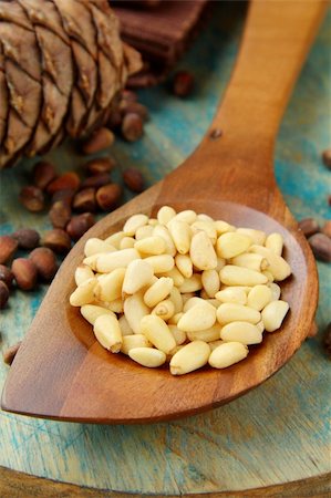 Pine nuts in a wooden spoon with cedar cones Stock Photo - Budget Royalty-Free & Subscription, Code: 400-05748541
