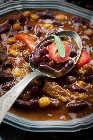 Chili con carne plate. Mexican traditional dish in rustic setting Stockbilder - Microstock & Abonnement, Bildnummer: 400-05748565