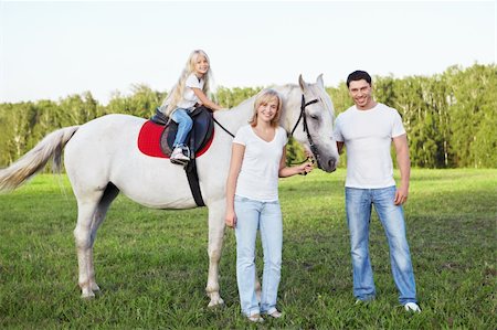 simsearch:400-04660370,k - Attractive family with a horse Photographie de stock - Aubaine LD & Abonnement, Code: 400-05748584