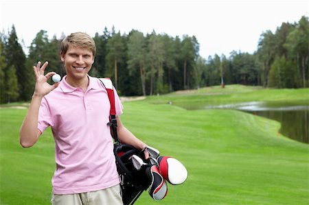 simsearch:400-05748592,k - A young man with the ball on the golf course Stock Photo - Budget Royalty-Free & Subscription, Code: 400-05748587