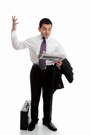 frustrated man with briefcase - A smartly dressed businessman reading the newspaper and throwing up his hands in disbelief.  Parts have been intentionally blurred.  White background. Stock Photo - Budget Royalty-Free & Subscription, Code: 400-05748647