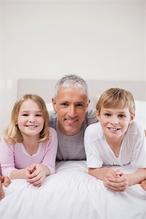 simsearch:400-04193152,k - Portrait of siblings and their father posing in a bedroom Stockbilder - Microstock & Abonnement, Bildnummer: 400-05749405