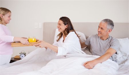 Girl serving breakfast to her parents in their bedroom Stock Photo - Budget Royalty-Free & Subscription, Code: 400-05749428