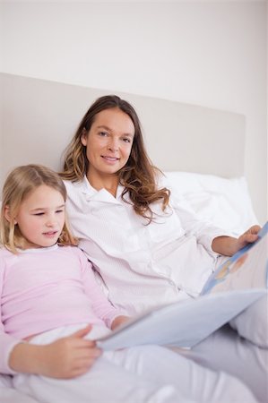 simsearch:400-05749645,k - Portrait of a girl reading a book with her mother in a bedroom Stock Photo - Budget Royalty-Free & Subscription, Code: 400-05749474