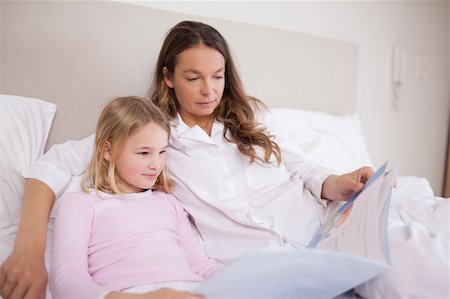 simsearch:400-05749645,k - Girl reading a book with her mother in a bedroom Stock Photo - Budget Royalty-Free & Subscription, Code: 400-05749473