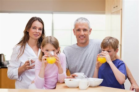 simsearch:400-05749624,k - Smiling family having breakfast in their kitchen Stock Photo - Budget Royalty-Free & Subscription, Code: 400-05749502