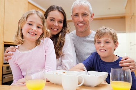 simsearch:400-05749624,k - Close up of a smiling family having breakfast in their kitchen Stock Photo - Budget Royalty-Free & Subscription, Code: 400-05749503