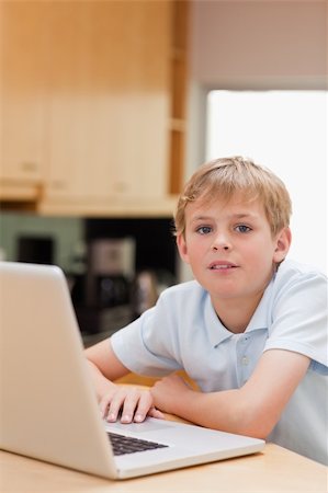 simsearch:400-04044137,k - Portrait of a boy using a notebook in a kitchen Stock Photo - Budget Royalty-Free & Subscription, Code: 400-05749518