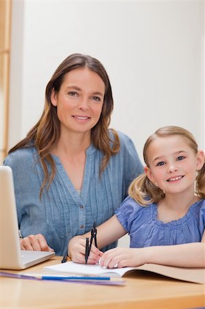 simsearch:400-04118366,k - Portrait of a beautiful woman helping her daughter doing her homework in a kitchen Photographie de stock - Aubaine LD & Abonnement, Code: 400-05749560