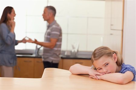 simsearch:400-06687238,k - Sad girl hearing her parents fitting in a kitchen Fotografie stock - Microstock e Abbonamento, Codice: 400-05749585