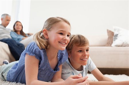 simsearch:400-05749645,k - Siblings playing video games while their parents are watching in a living room Stock Photo - Budget Royalty-Free & Subscription, Code: 400-05749624