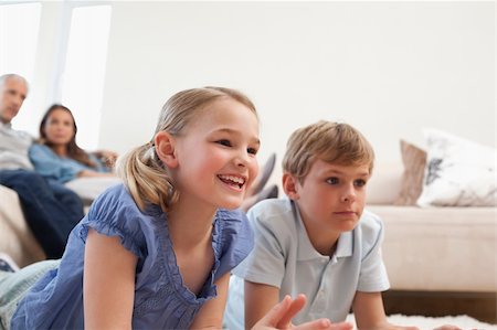 simsearch:400-05749624,k - Children playing video games while their parents are watching in a living room Stock Photo - Budget Royalty-Free & Subscription, Code: 400-05749623