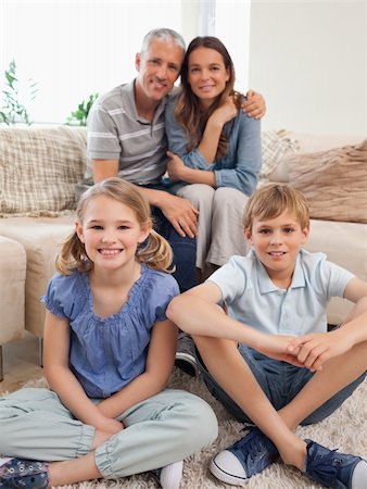 simsearch:400-05749624,k - Portrait of a happy family posing in a living room Stock Photo - Budget Royalty-Free & Subscription, Code: 400-05749639