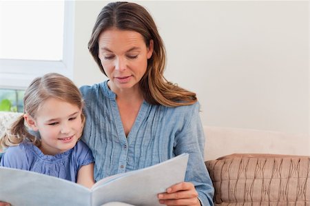 simsearch:400-05751566,k - Mother reading a book to her daughter in a living room Stock Photo - Budget Royalty-Free & Subscription, Code: 400-05749643