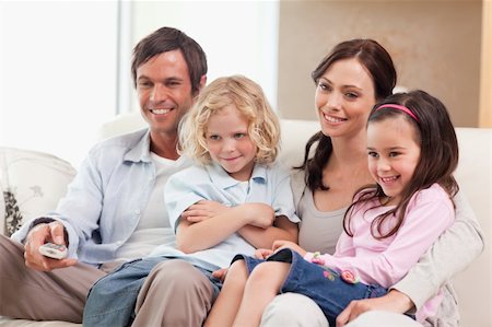 simsearch:400-05749624,k - Smiling family watching television together in a living room Stock Photo - Budget Royalty-Free & Subscription, Code: 400-05749655