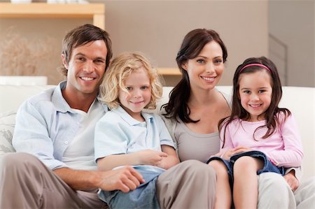 simsearch:400-05749624,k - Cute family watching television together in a living room Stock Photo - Budget Royalty-Free & Subscription, Code: 400-05749657