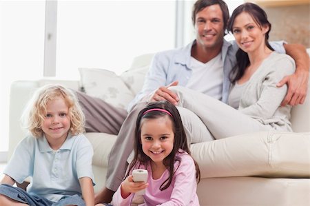 simsearch:400-05749624,k - Lovely family watching television in a living room Stock Photo - Budget Royalty-Free & Subscription, Code: 400-05749684