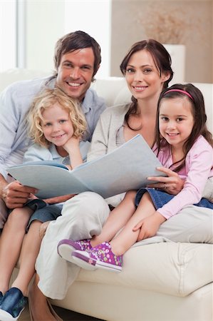 simsearch:400-04193532,k - Portrait of a family looking at a photo album in a living room Stock Photo - Budget Royalty-Free & Subscription, Code: 400-05749683