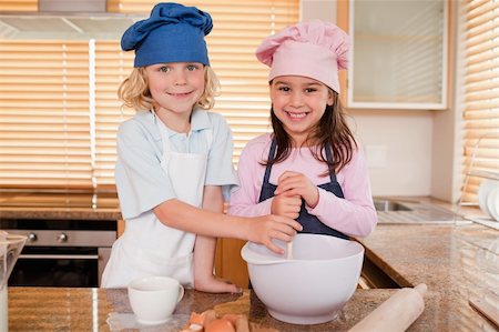 simsearch:400-06078465,k - Siblings baking together in a kitchen Stock Photo - Budget Royalty-Free & Subscription, Code: 400-05749764