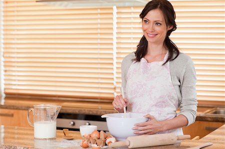 Gorgeous woman baking in her kitchen Stock Photo - Budget Royalty-Free & Subscription, Code: 400-05749770