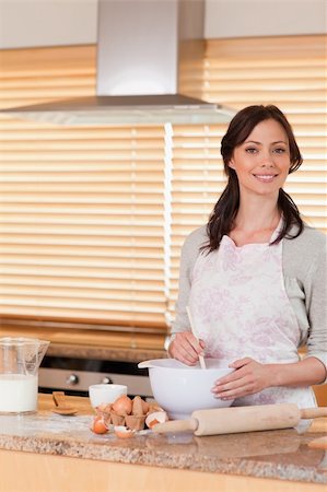 Portrait of a beautiful woman baking in her kitchen Stock Photo - Budget Royalty-Free & Subscription, Code: 400-05749772