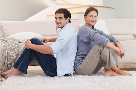 simsearch:400-04151970,k - Young couple sitting back to back in their living room Fotografie stock - Microstock e Abbonamento, Codice: 400-05740042