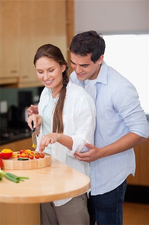 Portrait of a man teaching how to cook to his wife in their kitchen Stock Photo - Budget Royalty-Free & Subscription, Code: 400-05740098