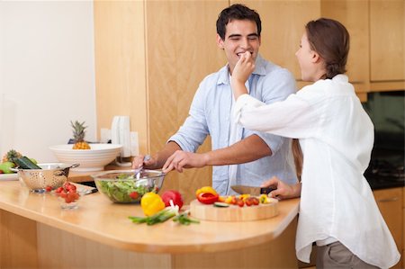 simsearch:400-04162443,k - Woman feeding her husband while cooking Fotografie stock - Microstock e Abbonamento, Codice: 400-05740093