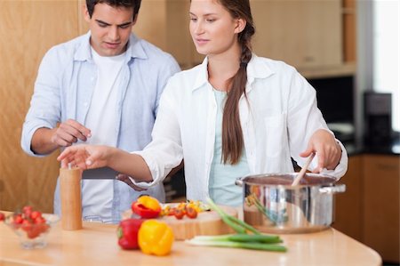 Cute couple using a tablet computer to cook in their kitchen Stock Photo - Budget Royalty-Free & Subscription, Code: 400-05740113