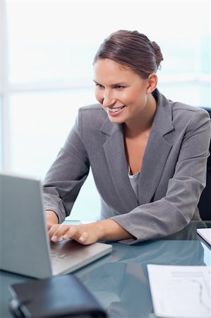 simsearch:400-04894274,k - Portrait of a businesswoman working with a laptop in her office Stock Photo - Budget Royalty-Free & Subscription, Code: 400-05740219