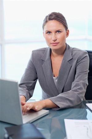 simsearch:400-04894274,k - Portrait of a serious businesswoman working with a laptop in her office Stock Photo - Budget Royalty-Free & Subscription, Code: 400-05740221