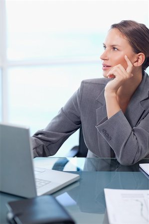 simsearch:400-05729276,k - Portrait of a doubtful businesswoman working with a laptop in her office Stock Photo - Budget Royalty-Free & Subscription, Code: 400-05740223