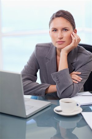 simsearch:400-08554629,k - Portrait of a serious businesswoman working with a notebook in her office Fotografie stock - Microstock e Abbonamento, Codice: 400-05740240